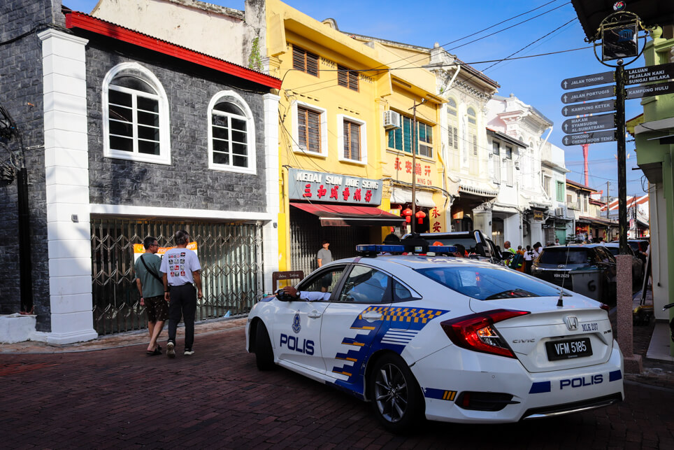 Police car in Malacca blocking the road near the temple Police car in Malacca blocking the road near the temple